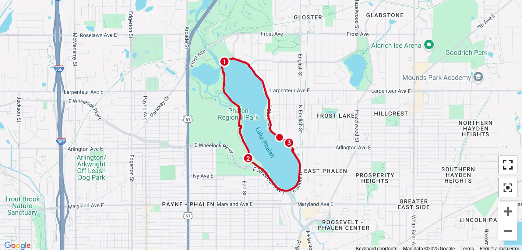 The image is a map displaying a running or walking route around Lake Phalen in Saint Paul, Minnesota. The route is highlighted in red and loops around Phalen Regional Park, following the shoreline of Lake Phalen. Three numbered markers (1, 2, and 3) are placed at different points along the course, possibly indicating mile markers or key locations. The surrounding area includes neighborhoods like East Phalen and Prosperity Heights, major roads like I-35E and Highway 61, and nearby landmarks such as Aldrich Ice Arena, Goodrich Park, and Arlington/Arkwright Off-Leash Dog Park. The map suggests a well-maintained, scenic course for outdoor recreation.