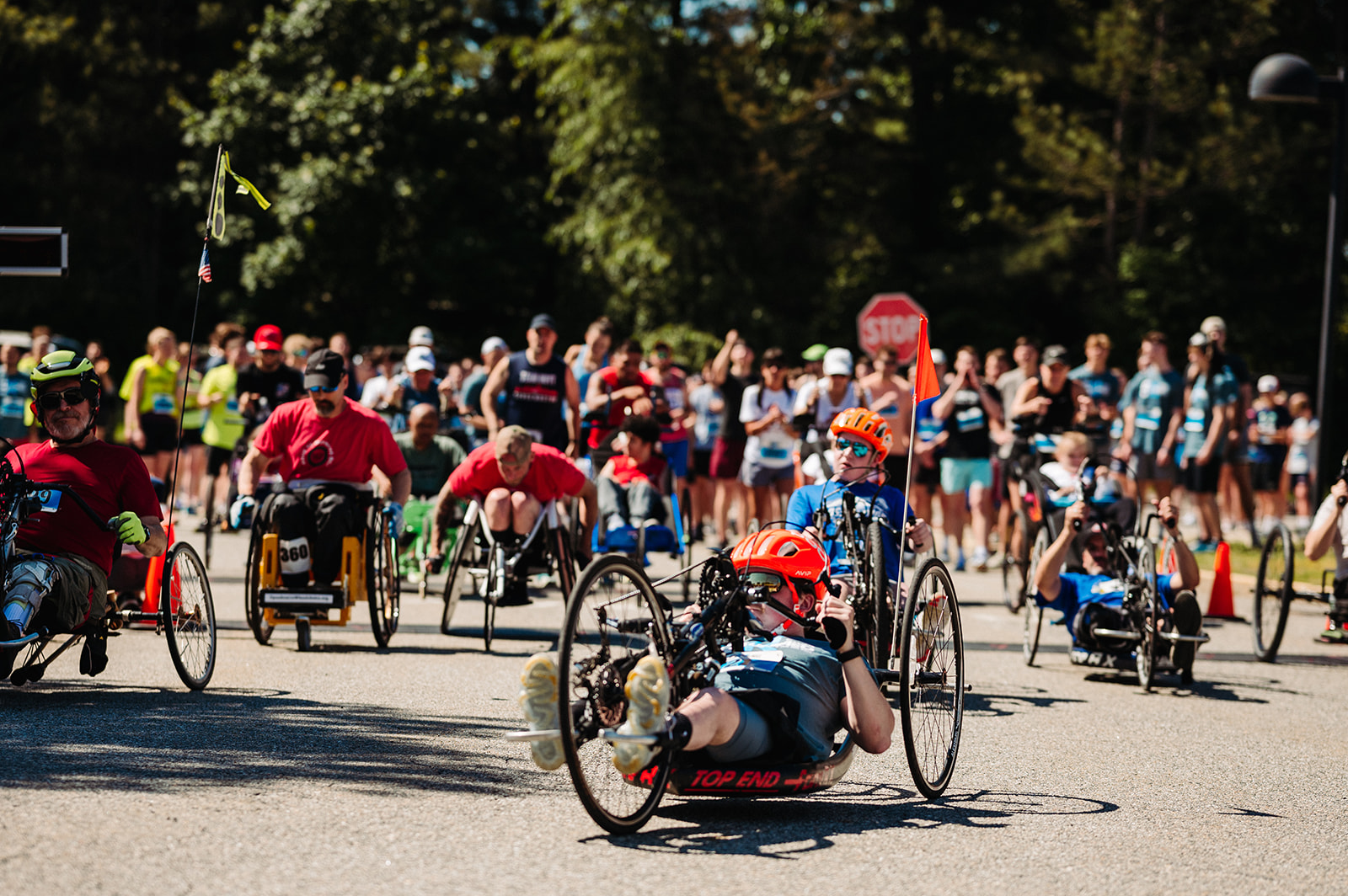 A start line picture of a variety of athletes with and without disabilities starting a road race.