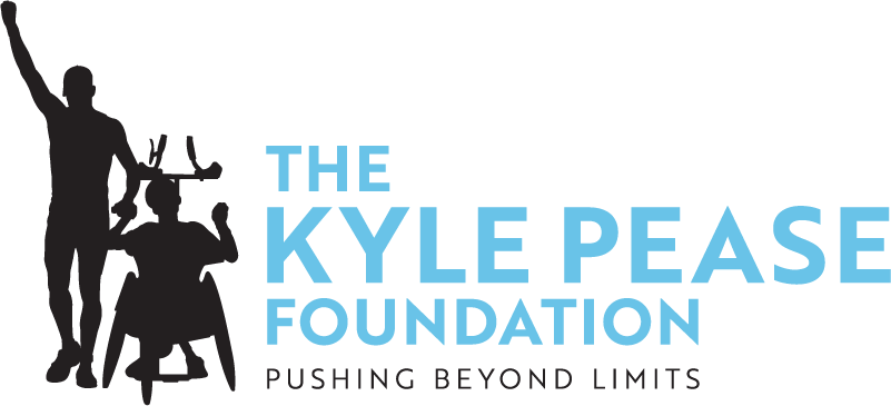 Logo for The Kyle Pease Foundation featuring a silhouette of a man pushing another person in a racing wheelchair, with the tagline “Pushing Beyond Limits.”
