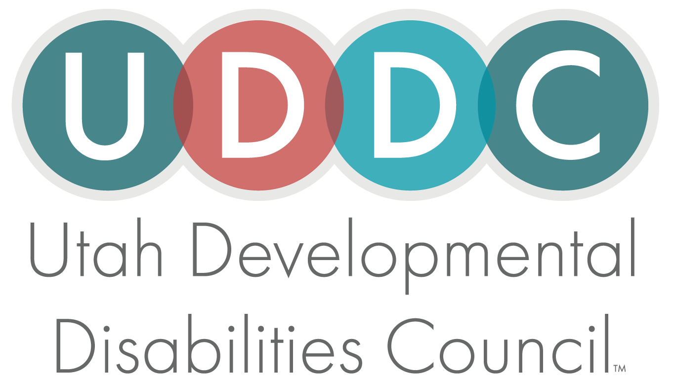 Alt Text: Logo for Utah Developmental Disabilities Council with the acronym “UDDC” in bold white letters over colorful circles, followed by the full organization name in gray text.